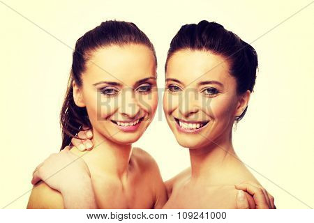Two attractive sisters with make up embracing.