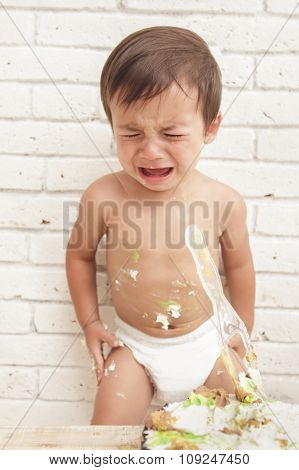 Handsome Toddler Crying While Playing Smash Cake