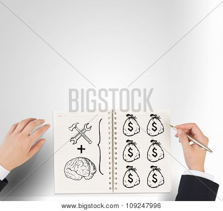 Businessman hands drawing money making formula in notepad