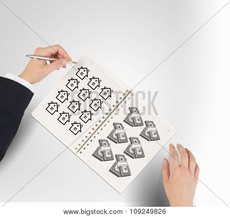 Businessman hands drawing money making formula in notepad