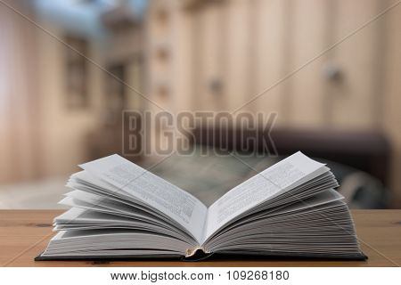 open book on old wooden table in the bedroom