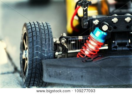 Detail shot of an automobile wheel and open engine. Car tuning concept