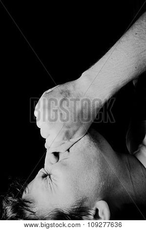 Pain face in darkness on hard light. Pain, anger and grief face expression