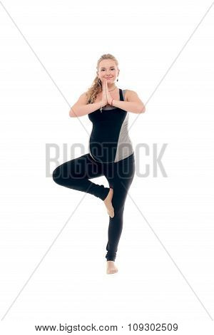 Pregnant woman doing sport exercises in yoga style