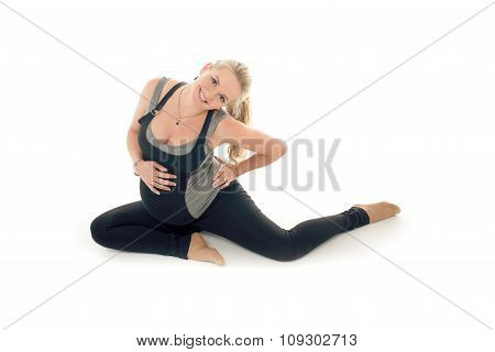 Pregnant woman doing sport exercises in yoga style
