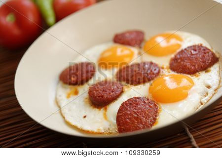 Fried eggs with sucuk in a frying pan
