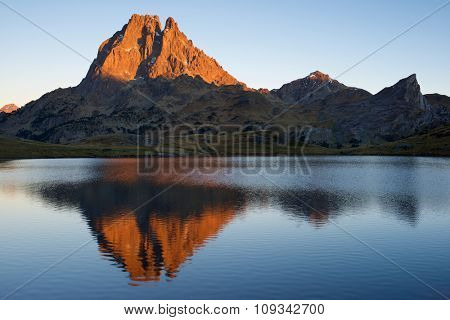 Midi Dossau Peak reflected in Ayous lake. Ossau Valley, Pyrenees National Park, Pyrenees, France.