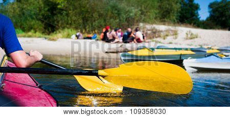 rowers on canoe floating to shore