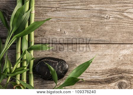 zen basalt stones and bamboo on the wooden baord background