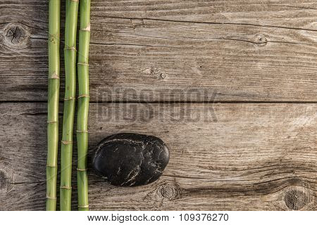 zen basalt stones and bamboo on the wooden baord background
