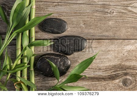 zen basalt stones and bamboo on the wooden baord background