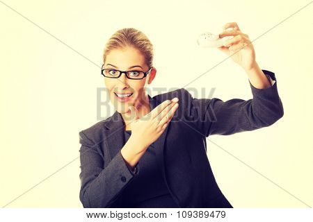Beautiful businesswoman with plane toy in hand