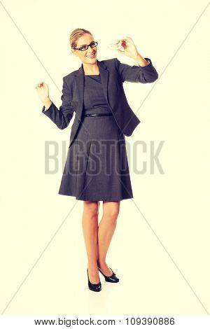 Beautiful businesswoman with plane toy in hand