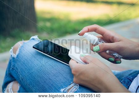 Woman In Blue Jeans Cleans Mobile Phone Antibacterial Wipes
