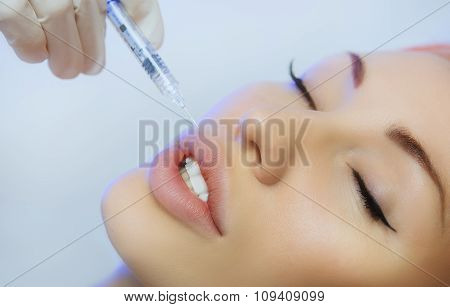 Woman Geting An Injection In Her Lips In Beauty Salon