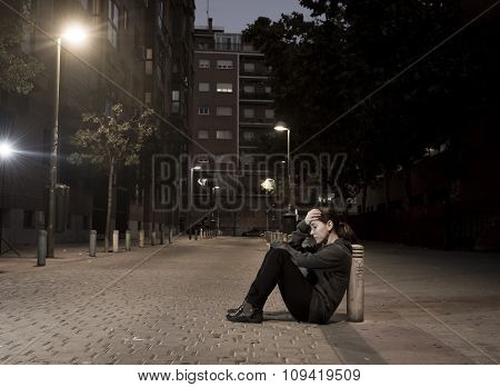 Young Sad Woman Sitting On Street Ground At Night Alone Desperate