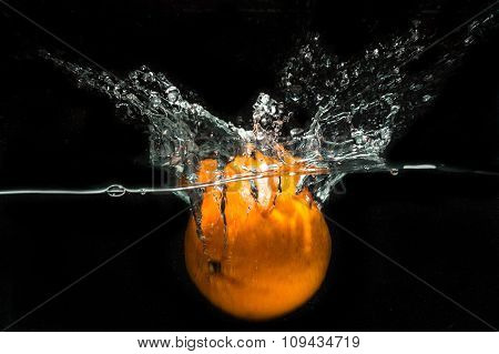studio picture concept. Mandarin oranges dropped into a container of water to obtain a water splash interesting