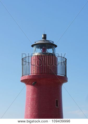 A View Of The Red Harbor Lighthouse Along The Tuscany Coastline In Castiglione Della Pescaia, Italy