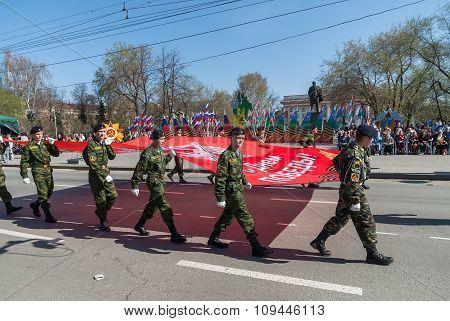 Cadets of patriotic club go on parade with flag