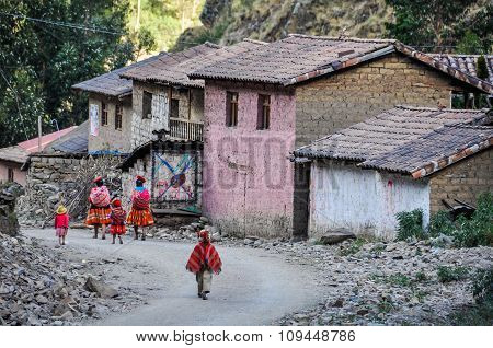 Quechua Family Going Home In A Village In The Andes, Ollantaytambo, Peru