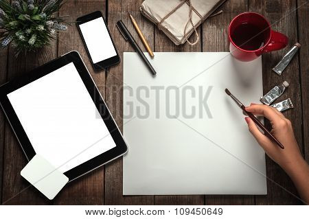 Woman's Hand With A Brush Paints On A Paper