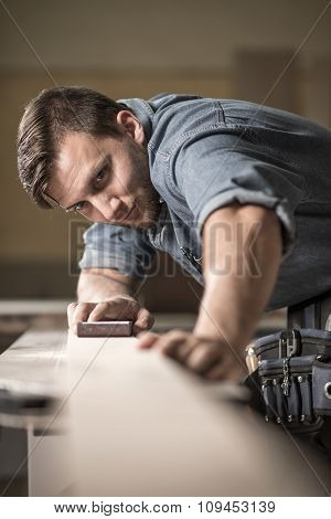 Joiner Polishing Wooden Board