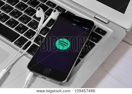 Iphone 5S On Laptop With Mobile Application For Spotify On The Screen