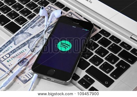 Iphone 5S On Laptop With Mobile Application For Spotify On The Screen