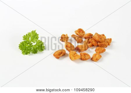 group of pork greaves on white background