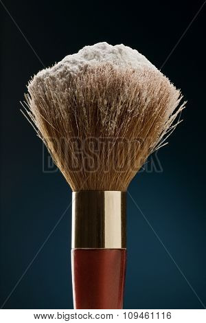 makeup brush with talcum powder on
