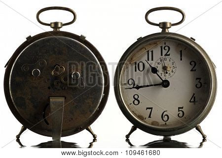 back and front of an old alarm clock