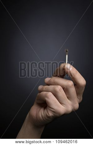 hand holding burning matches