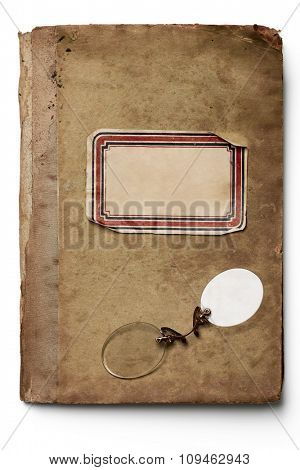 rimless glasses on an isolated old notebook