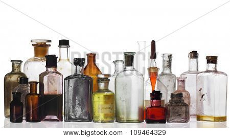 old pharmacist's bottles and beakers on white