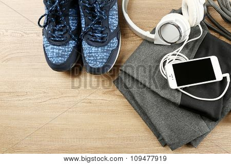 Sport clothes and equipment on wooden background