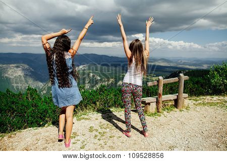 Two Girls Happy Dance On Peal Of Mountains