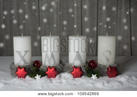 xmas candles with snow and fir as background