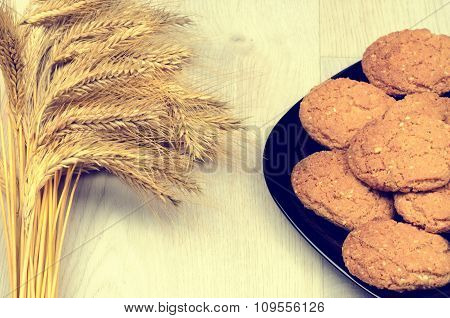 Wheat Ears And Cookies On A Wooden Background