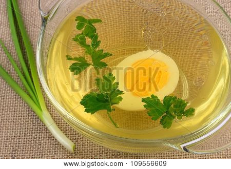 Broth with egg and parsley