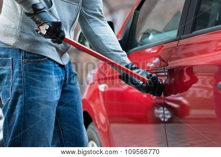 Thief Opening Car's Door With Crowbar