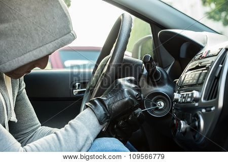 Thief Using Tool In Car