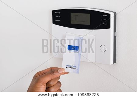 Person's Hand Holding Keycard To Open Door