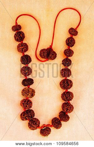 Powerful rudraksha combination mala kept on a plain cloth background