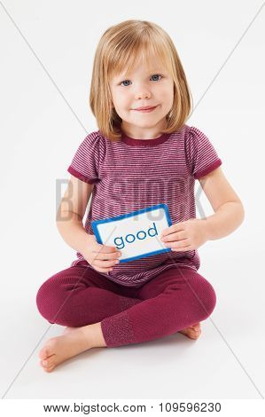 Young Girl In Studio Learning To Read Using Flash Card