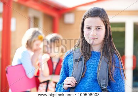 Unhappy Girl Being Gossiped About By School Friends