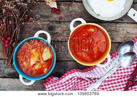 Traditional Ukrainian Russian vegetable borscht on the old wooden background. Ukrainian and russian
