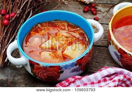 Traditional Ukrainian Russian vegetable borscht on the old wooden background. Ukrainian and russian