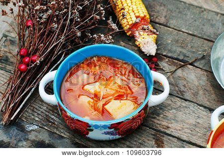 Traditional Ukrainian Russian vegetable borscht on the old wooden background. Ukrainian and russian