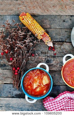 Traditional Ukrainian Russian vegetable borscht on the old wooden background. Ukrainian and russian