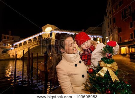Happy Mother And Daughter In Venice Looking On Christmas Tree